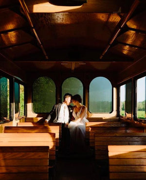 An image of a bride and a groom in a trolley at Charleston Tea Garden, a unique wedding venue and tea farm in Charleston, SC.