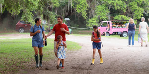 Parents and kids walking the grounds at Charleston Tea Garden, a family-friendly Charleston attraction