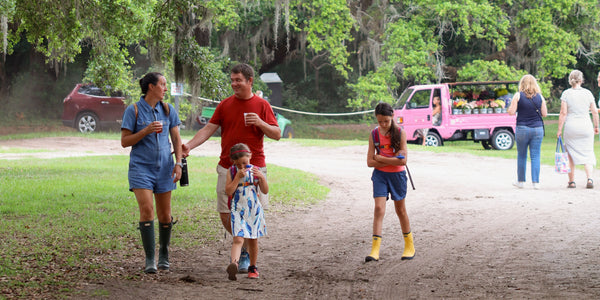 Parents and kids walking the grounds at Charleston Tea Garden, a family-friendly Charleston attraction