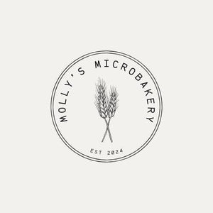 Circular Molly's Microbakery logo featuring two wheat stalks and the text Est 2024