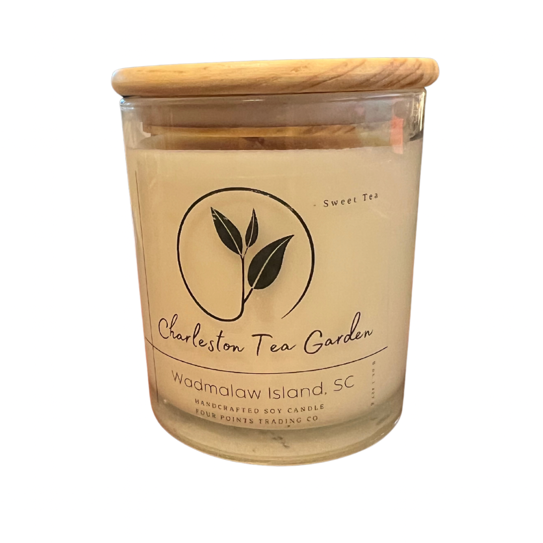 Glass jar candle with a wooden lid, featuring a sweet tea scent and labeled with Charleston Tea Garden from Wadmalaw Island, South Carolina.