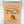 Silver Charleston Tea Garden tin labeled Limited Edition Green Tea and Peach, featuring illustrations of ripe peaches and green leaves on a peach colored label.