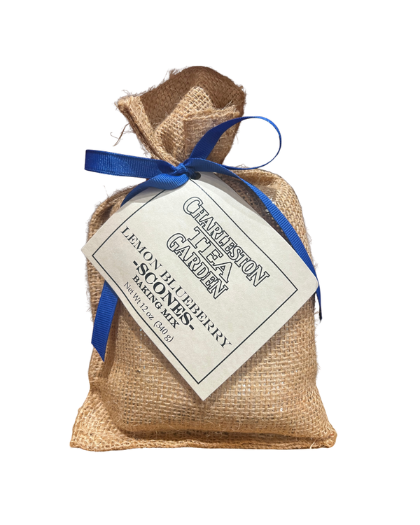 Small burlap bag tied with a blue ribbon containing lemon blueberry scone mix from Charleston Tea Garden, showcasing a rustic and charming packaging style.