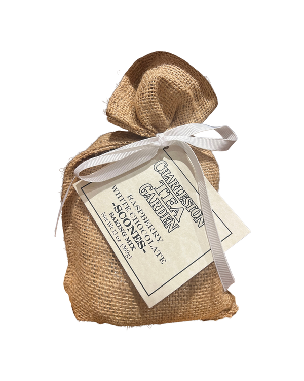 Small burlap bag tied with a white ribbon, featuring a tag labeled Raspberry White Chocolate Scone Mix from Charleston Tea Garden, perfect for gifting or enjoying homemade treats.