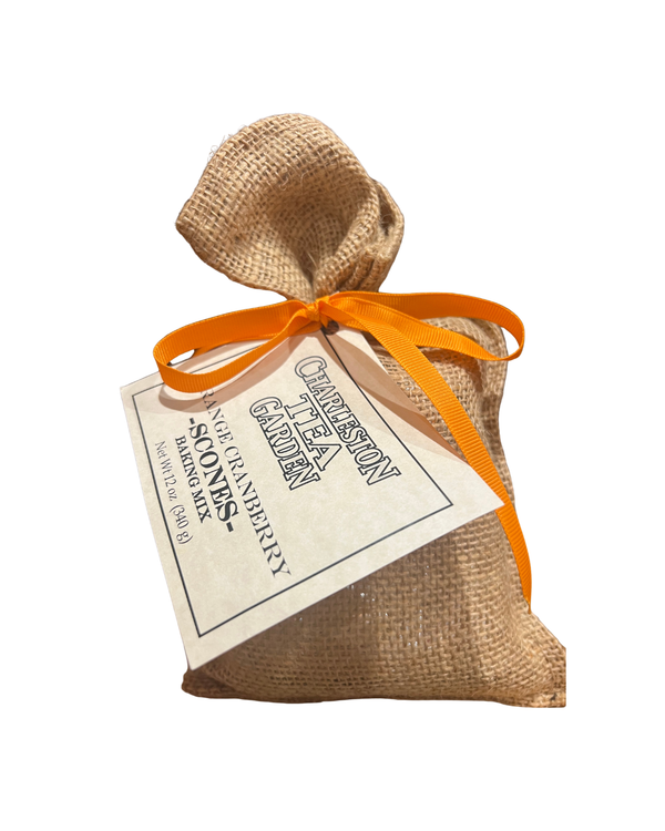 Small burlap sack tied with an orange ribbon containing orange cranberry scone baking mix with a Charleston Tea Garden label attached.