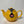 Bright mustard yellow ceramic teapot with a round body and a black tag featuring a British flag, designed for brewing 2 or 6 cups of tea.