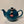 Glossy teal ceramic teapot with a classic round shape and a tag featuring the British flag, designed for brewing two to six cups of tea.