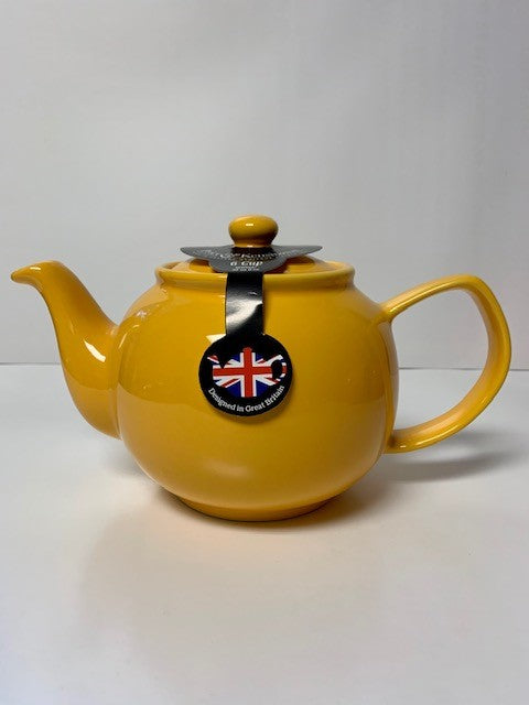 Bright yellow ceramic teapot with a simple rounded design and a tag featuring the British flag, ideal for brewing 2 to 6 cups of tea.