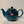 Dark teal ceramic teapot with a rounded body, curved spout, and handle, featuring a British flag tag, perfect for brewing two or six cups of tea.