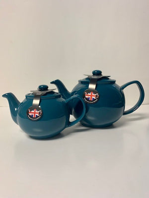 Two teal ceramic teapots, one smaller and one larger, displayed side by side against a plain background.