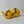 Two bright yellow ceramic teapots in 2 cup and 6 cup sizes, showcasing classic design with round bodies and curved spouts, perfect for a cozy tea experience.